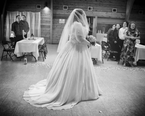 The bride walks down the aisle while the families stand at their tables. photos by Brianna Bivens - 2016