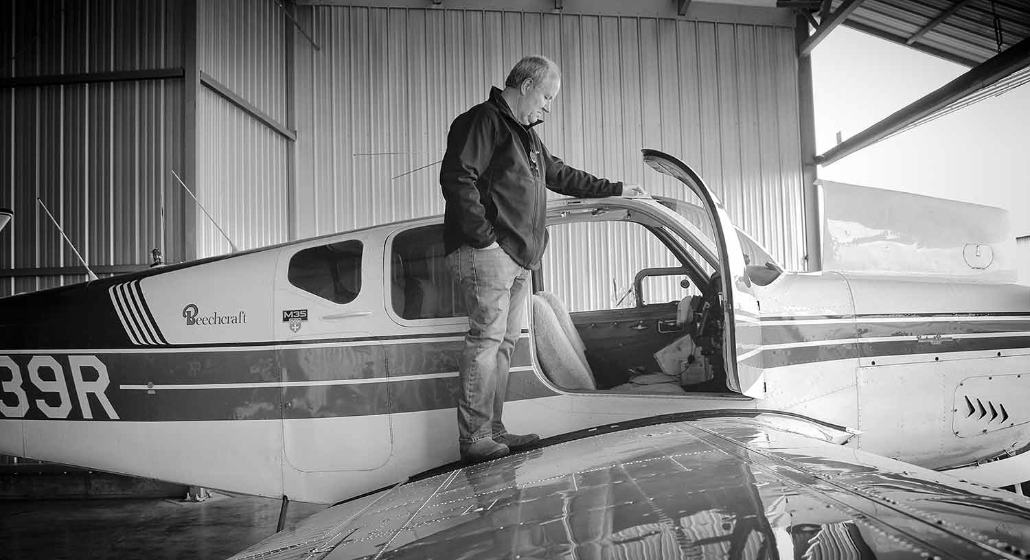 Lynn Prater admires his plane of 8 years.  photo by Emily Ross