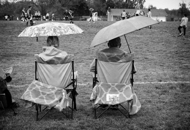 Two family members endure the rain and chilly weather as they watch a soccer game at LaFollette Elementary School. photo by Chelsea Babin - 2019