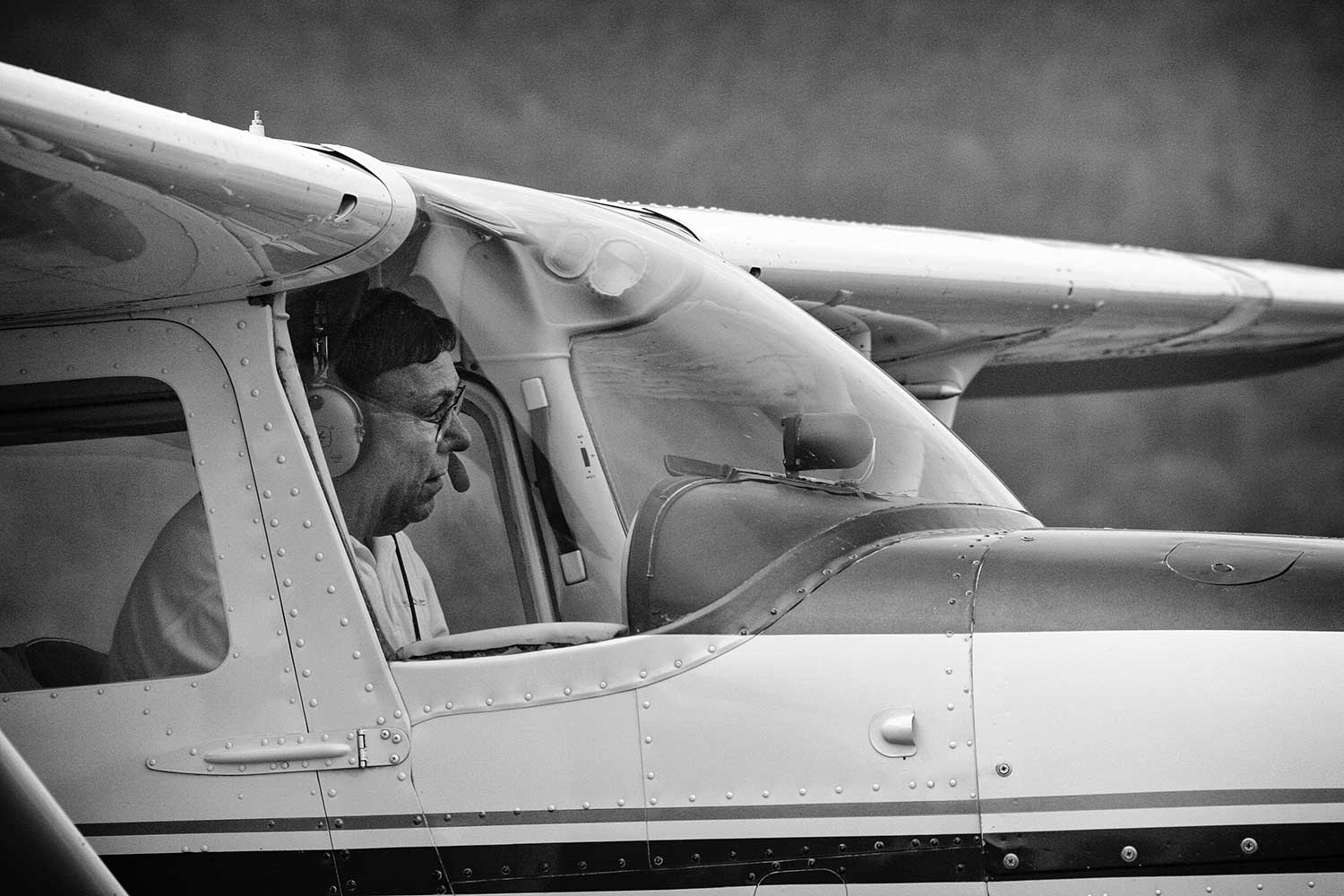 When he’s not flying business jets, Bert Loupe can usually be found managing Campbell County airport. This quiet Friday afternoon provides him the opportunity to roll one of the planes onto the tarmac for a brief flight beneath the grey sky. photos by Jamie Wilson - 2007