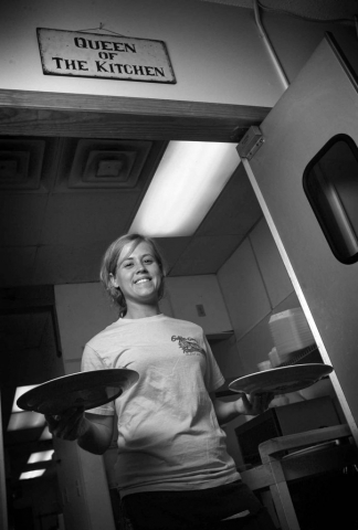Lindsey Ratliff, a waitress at The Diner, poses for a quick photo in between running plates out to customers. Photo by Adam Brimer - 2007