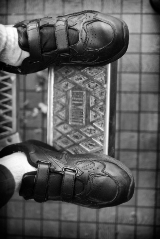 Granville Cornett’s shoes reflect the classic style of Ray Beeler’s barber chair. Photo By Samantha Thornton. - 2008