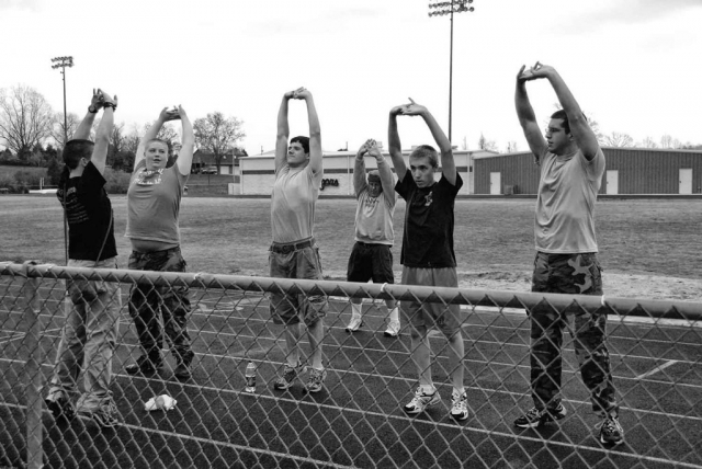 Left To Right: Robert Sopha, Adam Hunter, Tyler Allen, Col. Salveson, Noah Carr, and J. Jeffers. Part of the Raiders team stretches in preparation for a ROTC two-and-a-half mile run. photo by James Bolton - 2009
