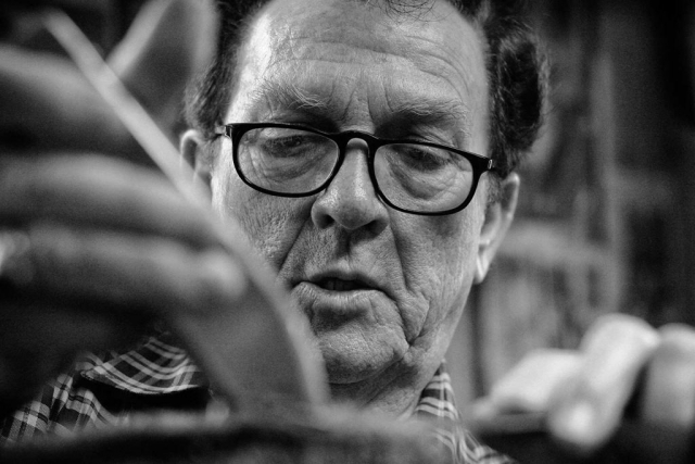 Ray “The Barber” Beeler focuses intently on the task at hand--telling stories and entertaining his customers. photo by Ben Moser - 2009