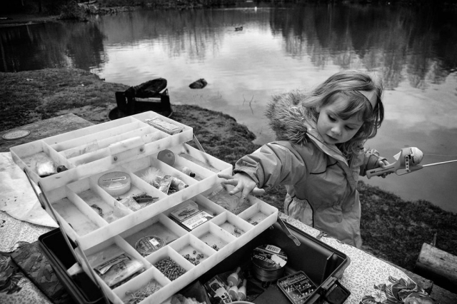 Isabella Ball, 3, examines a fishing lure while camping at Cove Lake State Park. photo by Jordan Vest - 2009