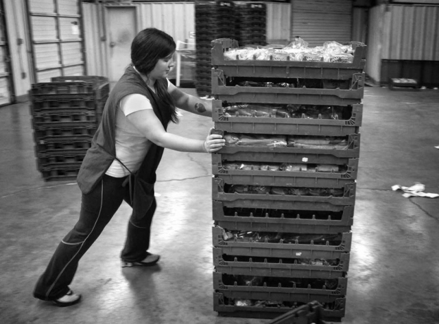 Carol Longmire pushes bread to be sold at Flower’s discount bakery store. photo by Michael Agreda - 2013