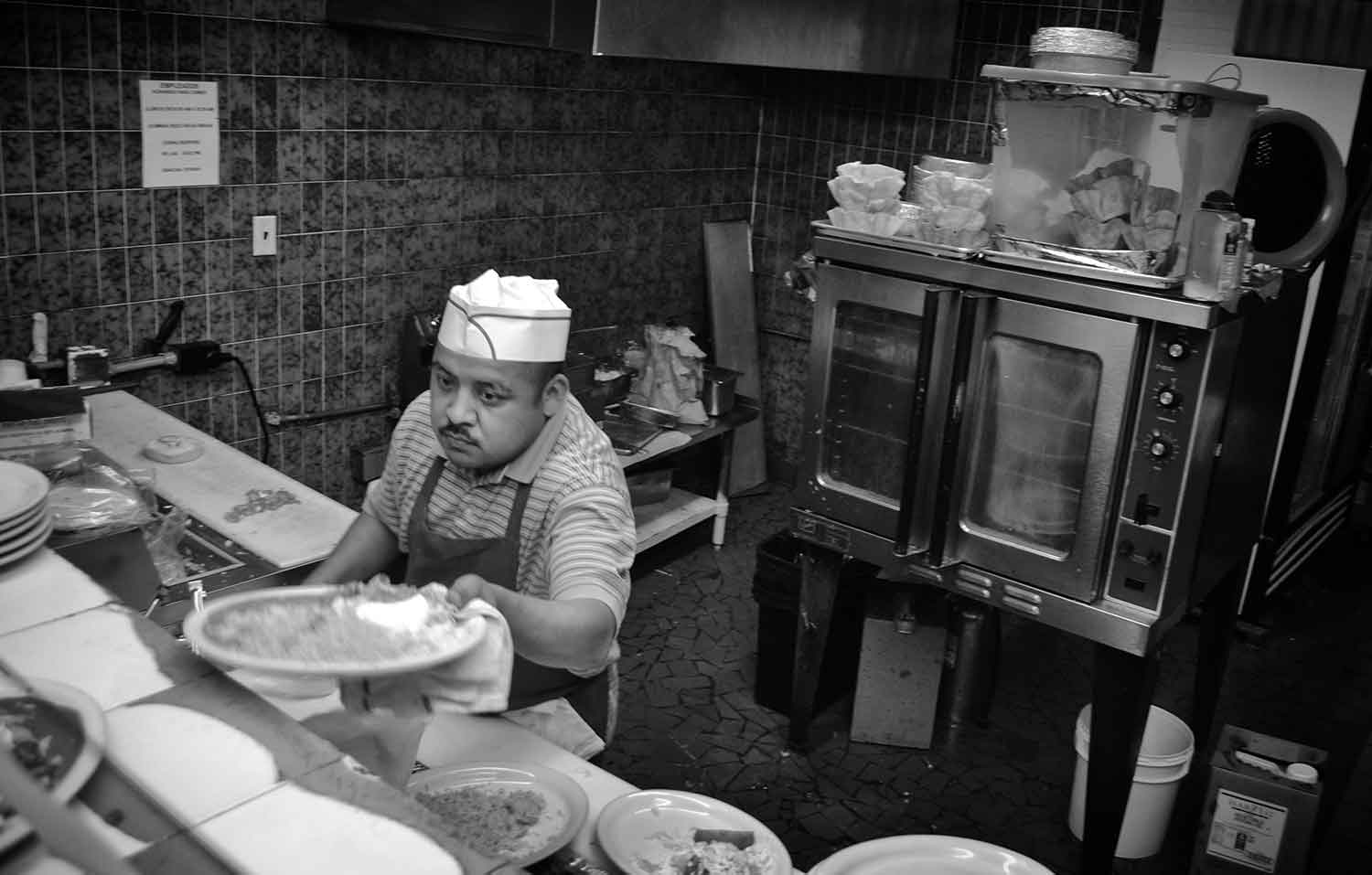 Felipe Corria prepares lunch dishes at El Pueblito Mexican restaurant. photo by Ellyn E. Fulton - 2014