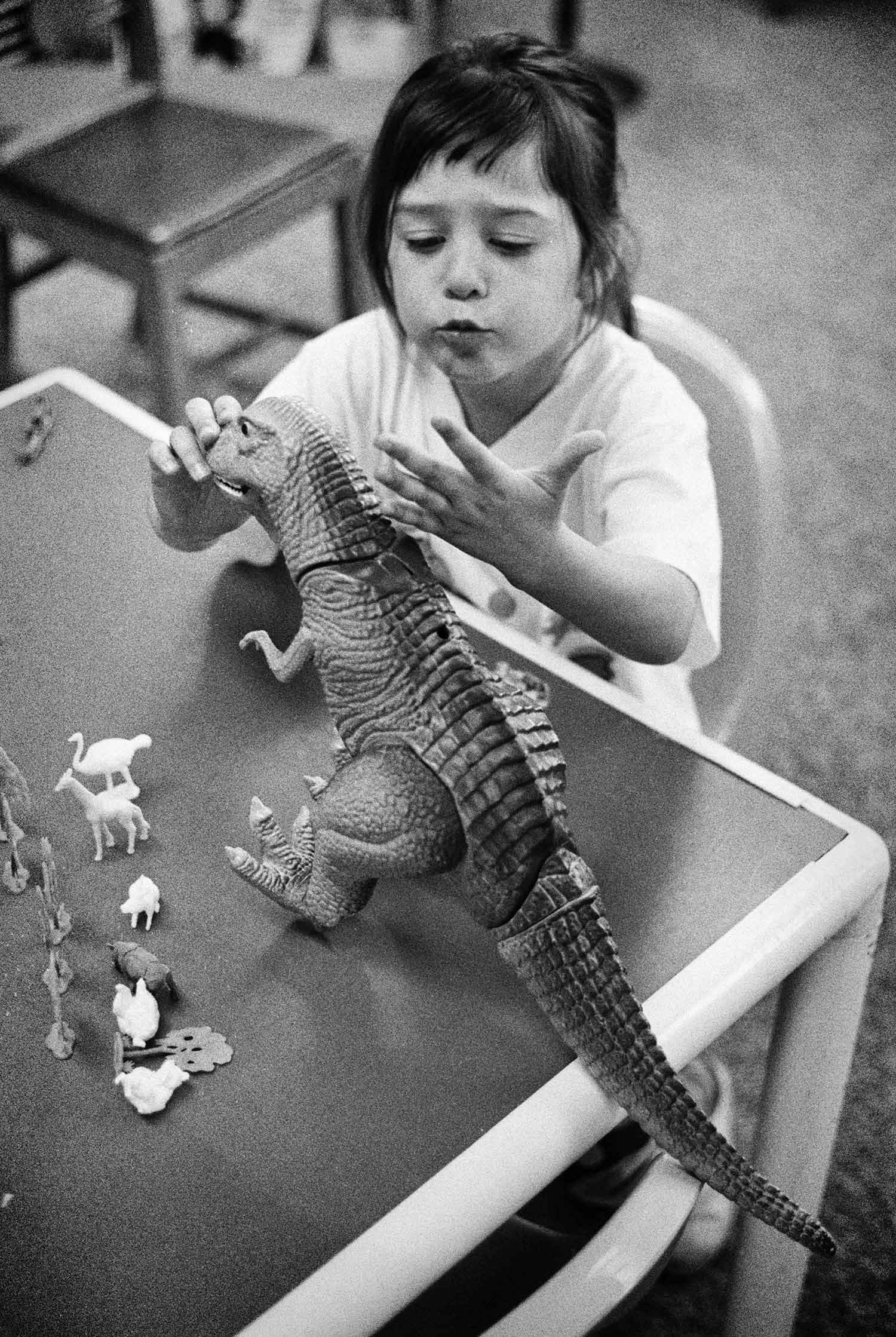 While her mother looks for books in the LaFollette Public Library, Alyssa Jacoby finds the toys to be more entertaining. Photo by Heather Spurgeon - 1995