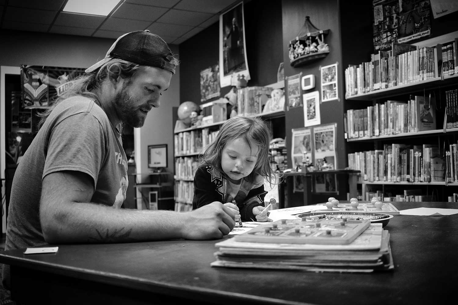 Ava and her “Pop Pop” Nick Ross, enjoy their time coloring on a rainy morning at the LaFollette Public Library. photo by Haley Guidry - 2019