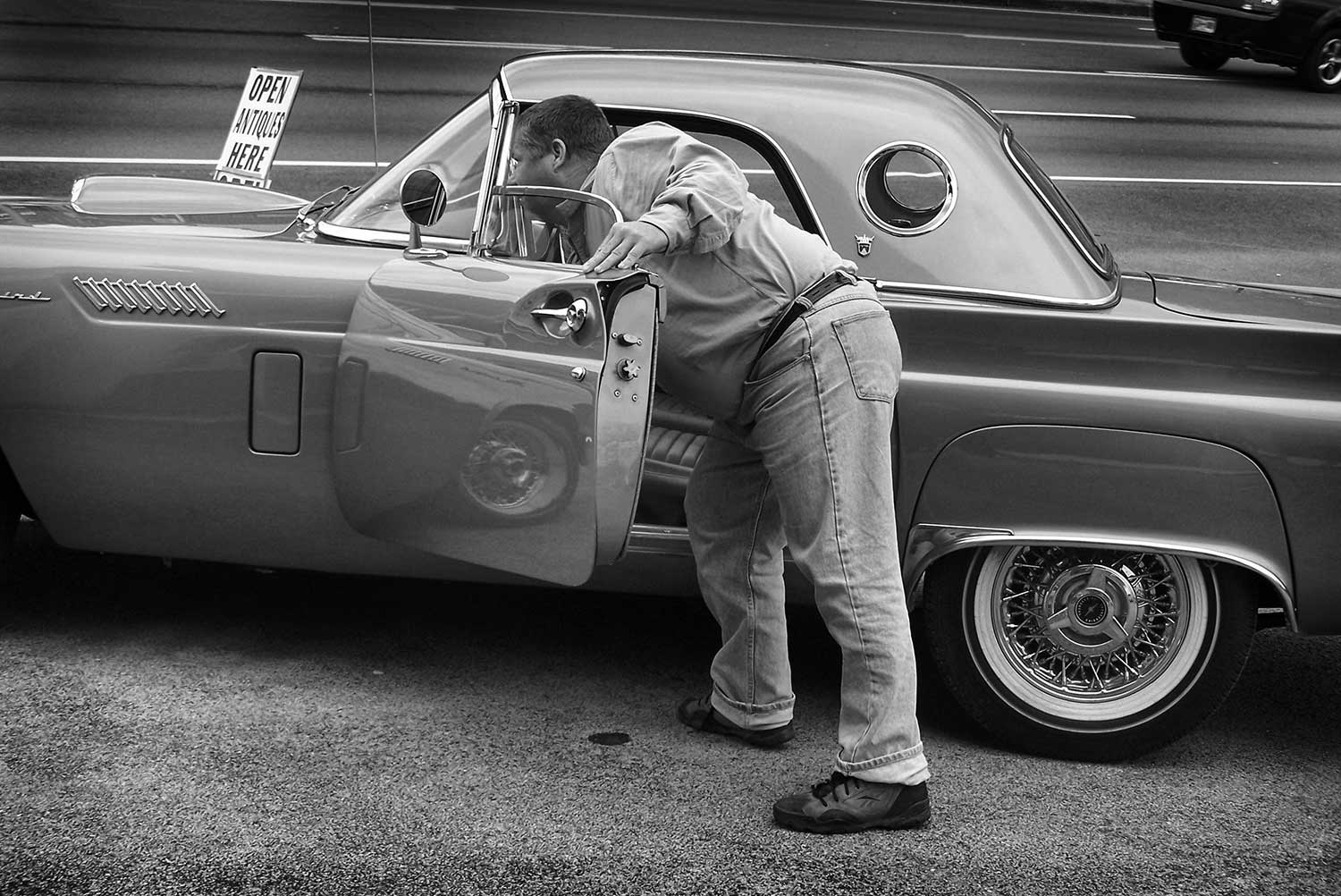 Mark Kitts prepares to pop the hood of one of Crazy Eddie’s antique cars. photo by Leigh Imhoff - 2009